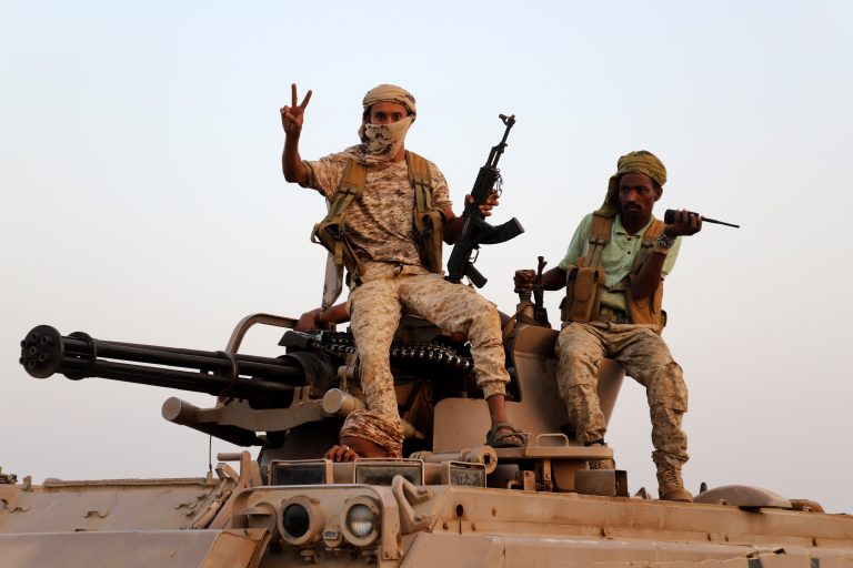 Drone Strike Houthi fighters posing on top of a tank