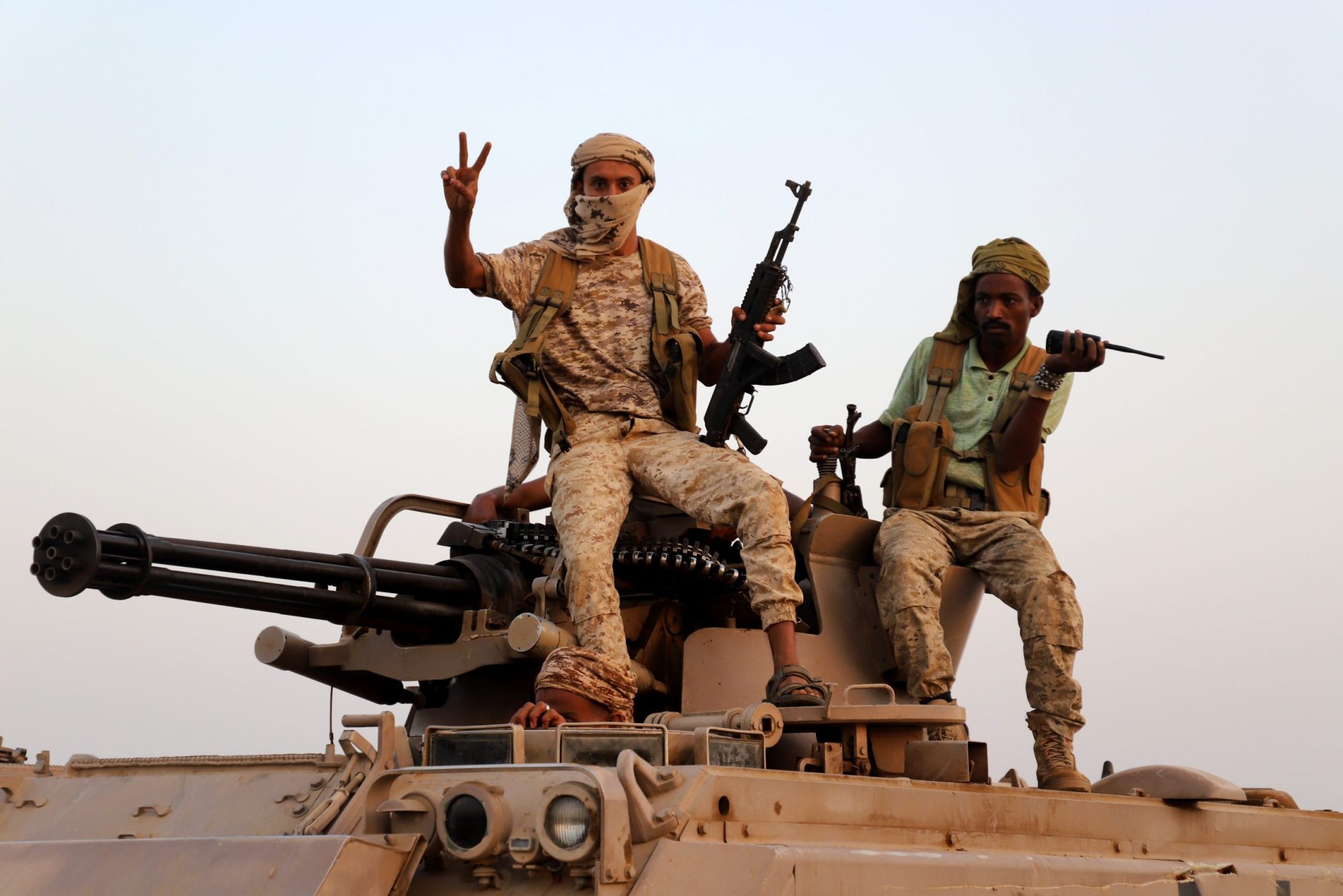 Drone Strike Houthi fighters posing on top of a tank
