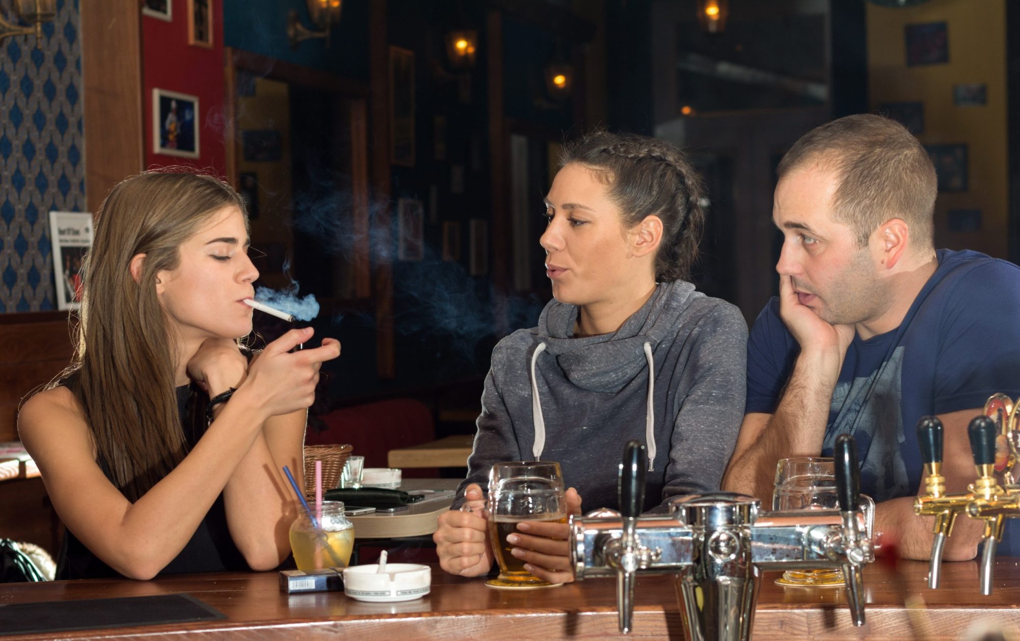 People in a pub, smoking. On an article about the Smoking Ban