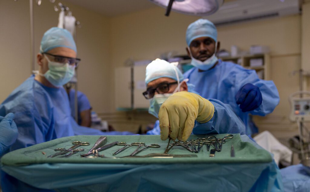 Dr. Jorge San Leon, orthopedic surgeon reaches for a surgical tool during the Lesser Antilles Medical Assistance Team mission at St. Jude Hospital in Vieux Fort, Saint Lucia, March 4, 2025. LAMAT is a U.S. Bone Cement is used